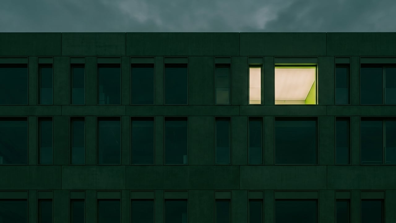 Modern facade with a repeating window grid at dusk