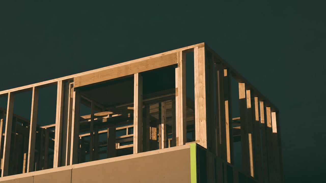Residential timber frame under construction at golden hour