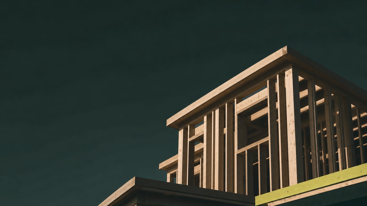 Residential timber frame under construction at golden hour