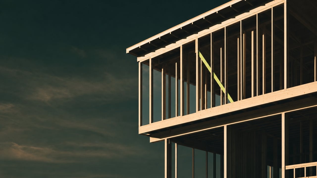 Residential timber frame under construction at golden hour