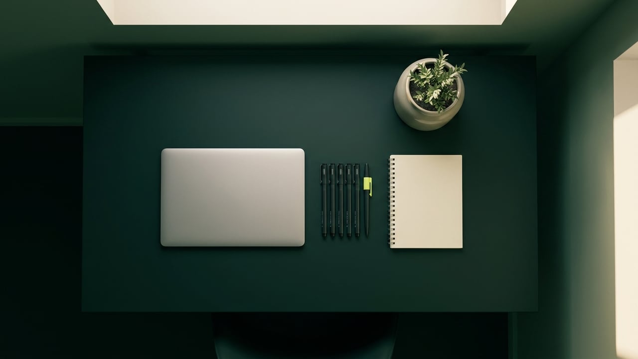 Tidy desk from above with drafting pens and a notebook