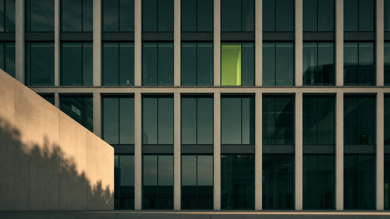 Modern facade with a repeating window grid at dusk