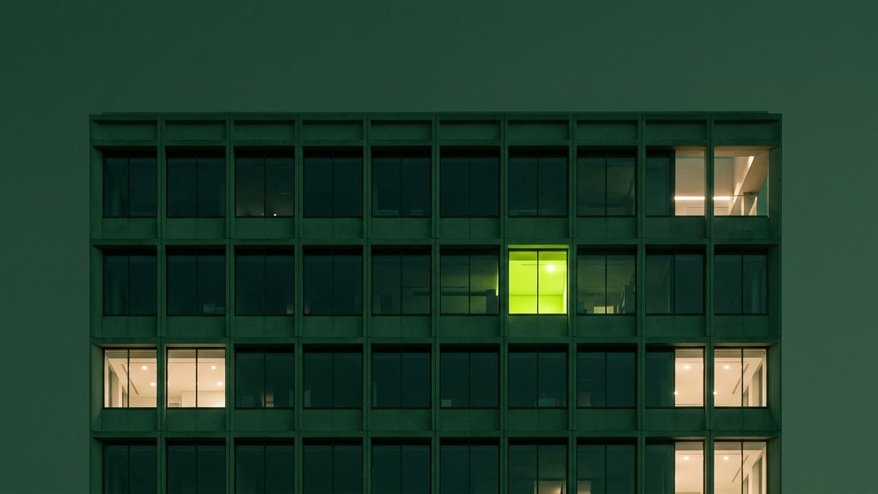 Modern facade with a repeating window grid at dusk