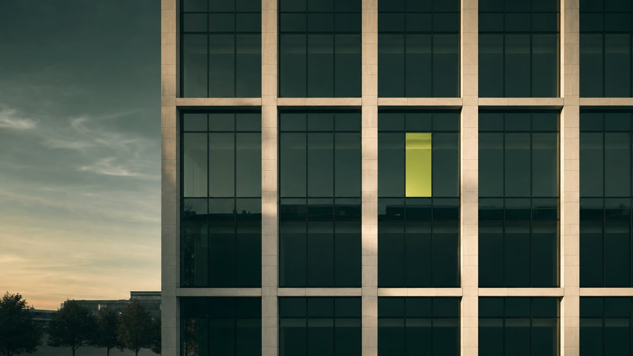 Modern facade with a repeating window grid at dusk