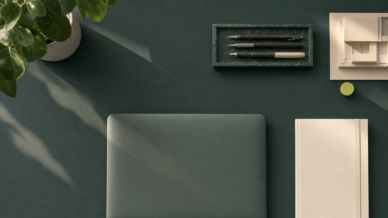 Tidy desk from above with drafting pens and a notebook